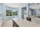 Kitchen with granite counters, stainless steel appliances, ample cabinet space, and views into the living area at 10205 Deercliff Dr, Tampa, FL 33647