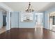 Open concept living room featuring hardwood floors, bar seating into kitchen, and view of outdoor patio at 10205 Deercliff Dr, Tampa, FL 33647
