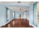 Open concept living room featuring hardwood floors, high tray ceilings and archway at 10205 Deercliff Dr, Tampa, FL 33647