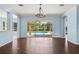 Bright living room with hardwood floors, chandelier and sliding glass doors leading to a screened in pool at 10205 Deercliff Dr, Tampa, FL 33647