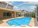 Inviting in-ground pool with screened enclosure and a covered patio, perfect for outdoor enjoyment at 10205 Deercliff Dr, Tampa, FL 33647