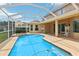 Inviting screened pool with a covered patio area, perfect for outdoor relaxation and entertaining at 10205 Deercliff Dr, Tampa, FL 33647