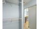 Walk-in closet showing metal shelving, light blue walls, and a door to the bathroom at 10205 Deercliff Dr, Tampa, FL 33647