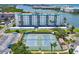 Aerial view featuring tennis courts and a well-maintained condominium complex at 10216 Regal Dr # 409, Largo, FL 33774