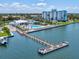 Breathtaking aerial view featuring a waterfront condominium, pool, and pier, ideal for luxurious living at 10216 Regal Dr # 409, Largo, FL 33774