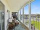 Relaxing balcony featuring stylish wicker furniture and sliding glass doors with serene neighborhood views at 10216 Regal Dr # 409, Largo, FL 33774
