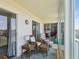 Cozy balcony seating area with wicker furniture, complemented by outdoor views and sliding glass door access at 10216 Regal Dr # 409, Largo, FL 33774