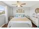 Relaxing bedroom with views to the outside, ceiling fan and white and neutral tones at 10216 Regal Dr # 409, Largo, FL 33774
