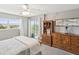 Bedroom with sliding door access to a balcony, and wooden dresser and shelving at 10216 Regal Dr # 409, Largo, FL 33774