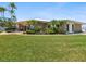 Charming clubhouse featuring stone accents, surrounded by lush landscaping and expansive green lawns at 10216 Regal Dr # 409, Largo, FL 33774