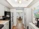 Hallway view into dining room with overhead lighting and decorative furnishings at 10216 Regal Dr # 409, Largo, FL 33774
