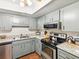 Well-equipped kitchen with stainless steel appliances and counter space at 10216 Regal Dr # 409, Largo, FL 33774