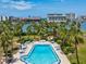 Inviting community pool surrounded by palm trees and manicured landscaping, perfect for relaxation and recreation at 10216 Regal Dr # 409, Largo, FL 33774