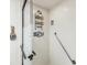 Shower featuring a glass door, white tiled walls, and mounted organizers at 10216 Regal Dr # 409, Largo, FL 33774