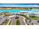 Expansive aerial view showcasing the lagoon and recreation area, including parking and food trucks at 11291 Cay Spruce Way, San Antonio, FL 33576