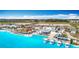Amazing aerial view of the lagoon, beach, outdoor dining, and playground in a vibrant community at 11291 Cay Spruce Way, San Antonio, FL 33576