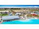 Aerial view of neighborhood lagoon, beach, outdoor amenities, and nearby community restaurants at 11291 Cay Spruce Way, San Antonio, FL 33576