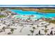 Expansive aerial view of lagoon with sandy beaches, beach chairs, playground and other water amenities at 11291 Cay Spruce Way, San Antonio, FL 33576