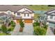 Aerial view of the townhome showcasing lush landscaping, water views and two-car garage at 11291 Cay Spruce Way, San Antonio, FL 33576
