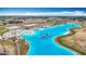 Community aerial view of a clear lagoon, white sand beaches and Gathering fun activities, and manicured lawns at 11291 Cay Spruce Way, San Antonio, FL 33576