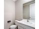 Well-lit half bathroom features a modern vanity with a large mirror and white trim at 11291 Cay Spruce Way, San Antonio, FL 33576