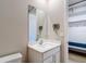 Half bathroom with modern vanity and decorative wall hooks located near the entry to the home at 11291 Cay Spruce Way, San Antonio, FL 33576
