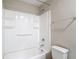 A clean bathroom features a tub, showerhead, and a towel rack in a serene, neutral color scheme at 11291 Cay Spruce Way, San Antonio, FL 33576