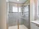 Elegant bathroom showcasing a tiled walk-in shower with a glass door at 11291 Cay Spruce Way, San Antonio, FL 33576