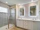 Modern bathroom featuring a double vanity, LED mirrors, and a tiled walk-in shower at 11291 Cay Spruce Way, San Antonio, FL 33576