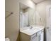 Bathroom with a white vanity, quartz countertop, a large mirror, and ample lighting at 11291 Cay Spruce Way, San Antonio, FL 33576