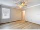 Bedroom with ceiling fan, window with blinds, and an entry door at 11291 Cay Spruce Way, San Antonio, FL 33576