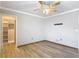 A bedroom featuring wood-look floors, a ceiling fan, and a walk-in closet with shelving at 11291 Cay Spruce Way, San Antonio, FL 33576