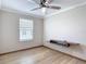 Bedroom with a modern ceiling fan, window, and built-in media console at 11291 Cay Spruce Way, San Antonio, FL 33576