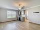 Large bedroom with hardwood floors, a ceiling fan, a window, and a gray wet bar at 11291 Cay Spruce Way, San Antonio, FL 33576