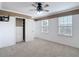 This bedroom features carpet, paneled walls, two windows, and a closet with drawers at 11291 Cay Spruce Way, San Antonio, FL 33576