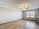 Large bedroom with hardwood floors, a ceiling fan, and a large window allowing ample natural light at 11291 Cay Spruce Way, San Antonio, FL 33576