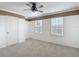 This bedroom features neutral carpet, paneled walls, and two windows for natural light at 11291 Cay Spruce Way, San Antonio, FL 33576