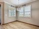Dining area featuring wood-look floors, windows, white shutters and nautical-themed decorations at 11291 Cay Spruce Way, San Antonio, FL 33576