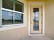 Exterior view of door with window showcasing the nice outdoor landscaping and natural light at 11291 Cay Spruce Way, San Antonio, FL 33576