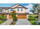 Charming townhome featuring a two-car garage, manicured landscaping and serene water views at 11291 Cay Spruce Way, San Antonio, FL 33576