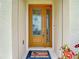 Inviting front door with glass detailing, a 'Welcome' mat and side-light window at 11291 Cay Spruce Way, San Antonio, FL 33576