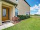 Charming front door with decorative glass, surrounded by lush greenery and manicured lawn at 11291 Cay Spruce Way, San Antonio, FL 33576