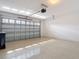Clean, spacious garage with an epoxy floor, block walls, and overhead door at 11291 Cay Spruce Way, San Antonio, FL 33576