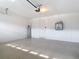 Well-maintained garage with epoxy floors and white-painted walls, offering ample storage and parking space at 11291 Cay Spruce Way, San Antonio, FL 33576