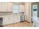 Bright kitchen featuring white cabinets, quartz countertops, and stainless steel appliances at 11291 Cay Spruce Way, San Antonio, FL 33576