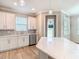 Open kitchen design featuring white cabinets, stainless steel appliances, and a large island at 11291 Cay Spruce Way, San Antonio, FL 33576