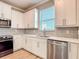 Modern kitchen with stainless steel appliances and white cabinets at 11291 Cay Spruce Way, San Antonio, FL 33576