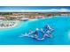 Expansive lagoon featuring a beachfront, recreation area, and inflatable water park offering a resort-style experience at 11291 Cay Spruce Way, San Antonio, FL 33576