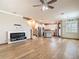 Spacious living room featuring wood floors, a modern fireplace, and an open concept kitchen at 11291 Cay Spruce Way, San Antonio, FL 33576