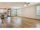 Bright and airy living space with wood floors, white trim and views of the kitchen area at 11291 Cay Spruce Way, San Antonio, FL 33576